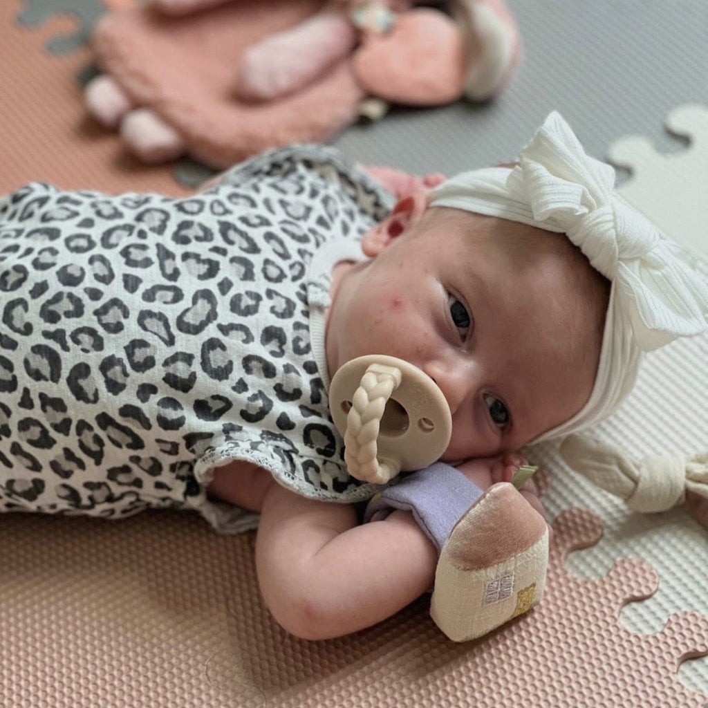 infant girl wearing an itzy bitzy wrist rattle