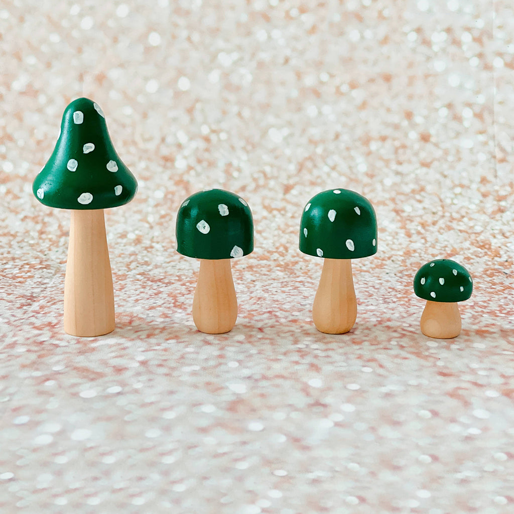 green spotty painted wooden mushrooms