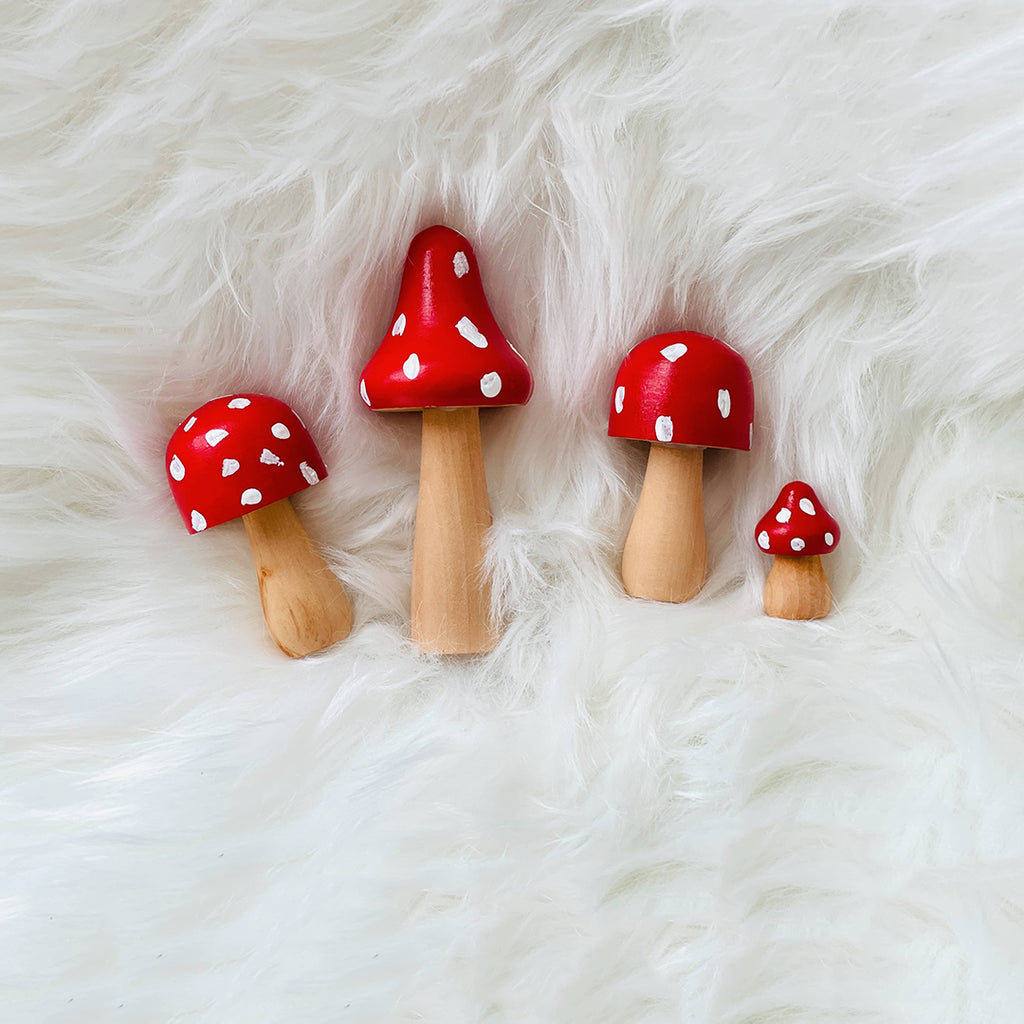 red pretend play painted wooden mushrooms with white spots