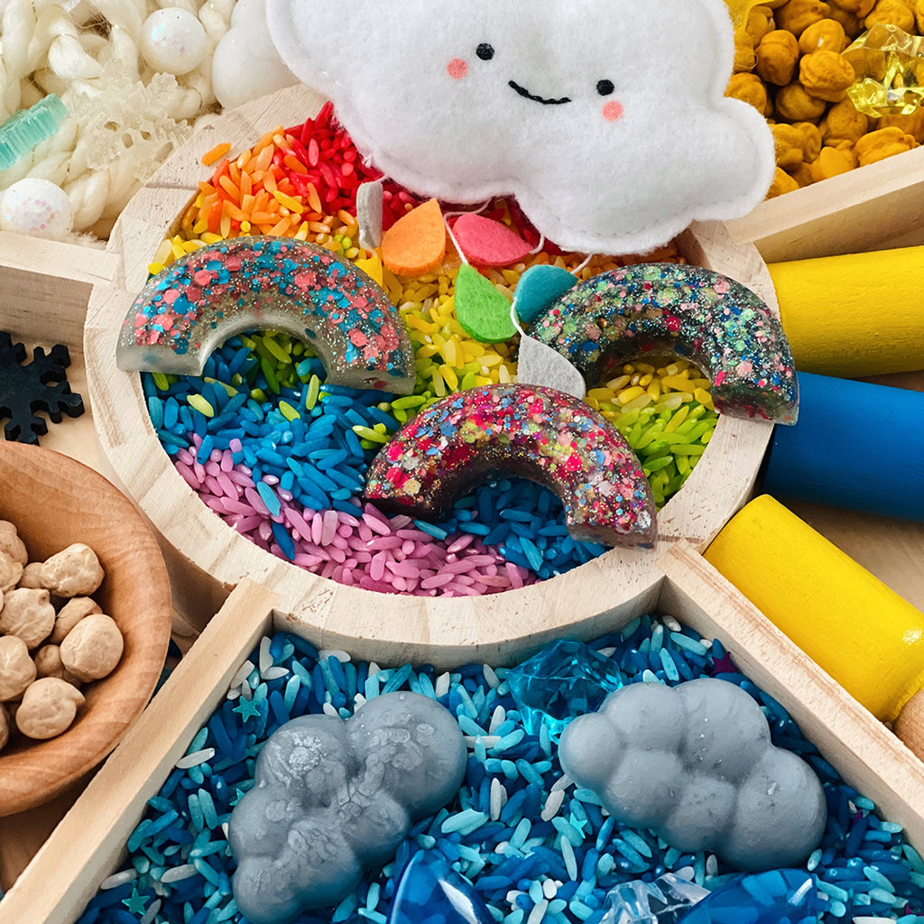 resin rainbow and cloud shapes for a child's weather themed Montessori sensory bin