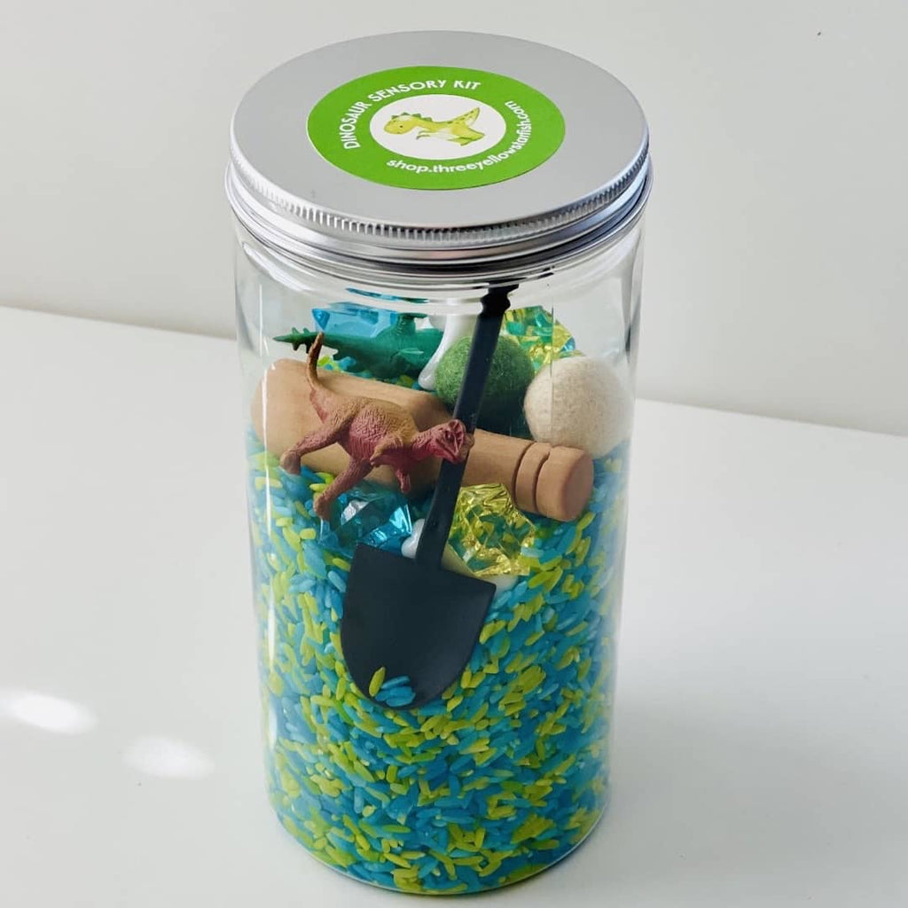 mini dinosaur sensory kit with blue and green dyed rice
