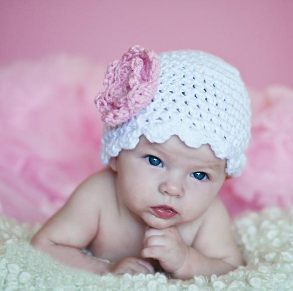 white crochet hat for baby girls with light pink flower accent