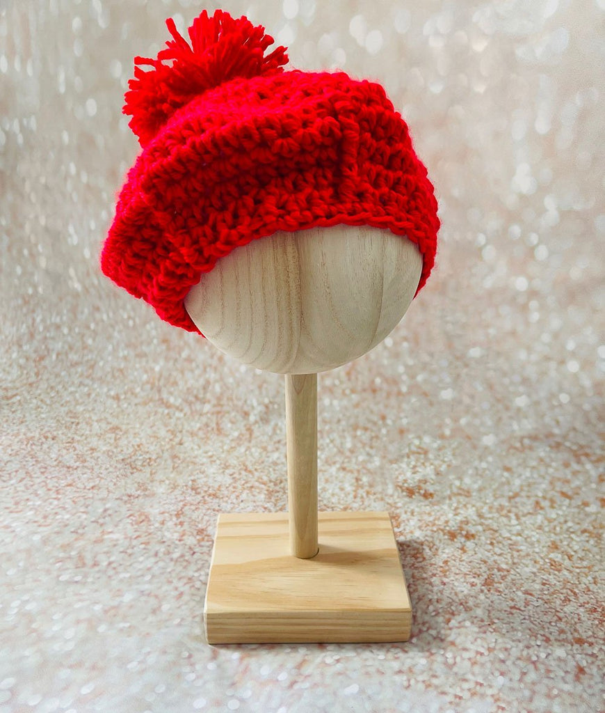 Bright red crocheted beret style baby pom pom hat