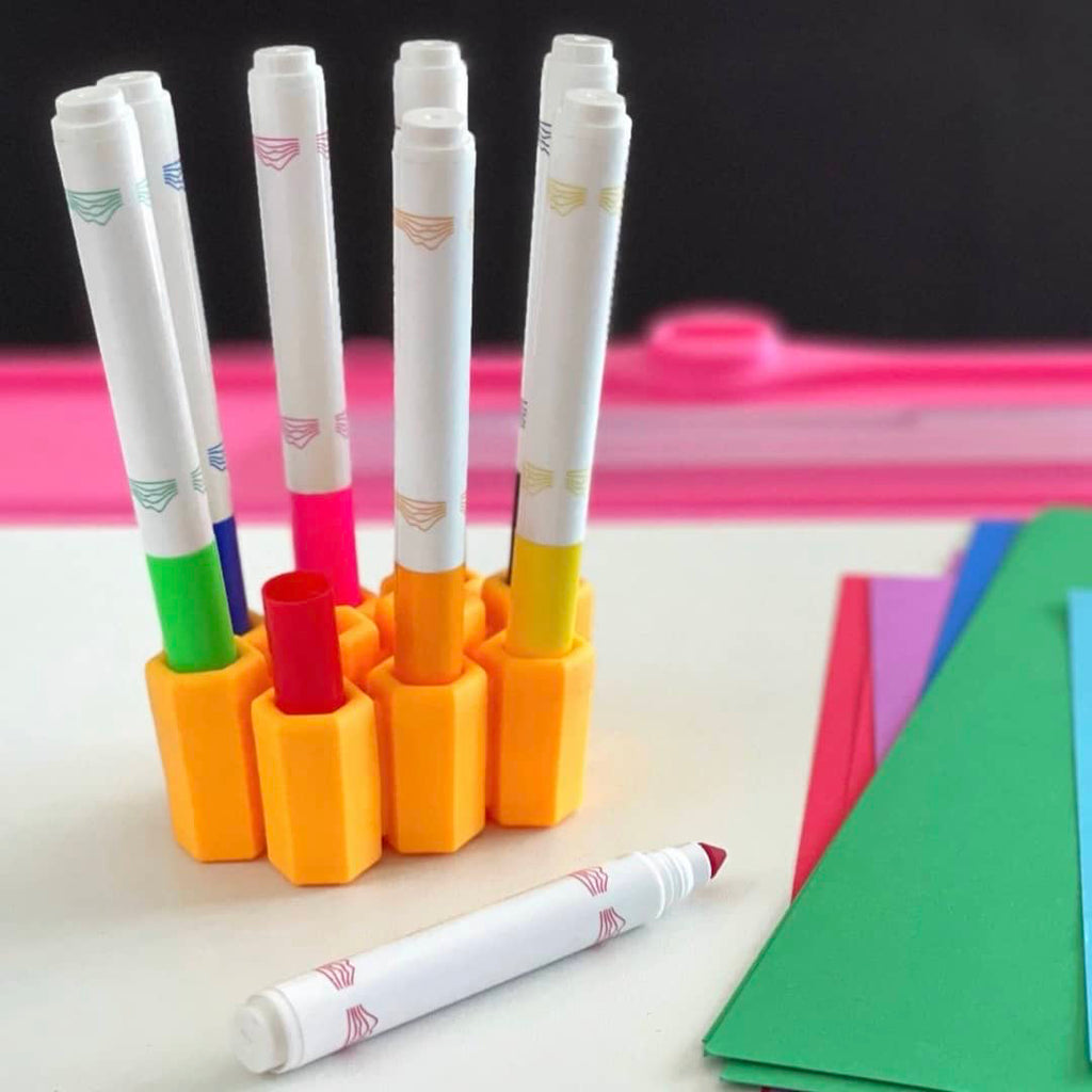 markers placed in a yellow silicone organizer