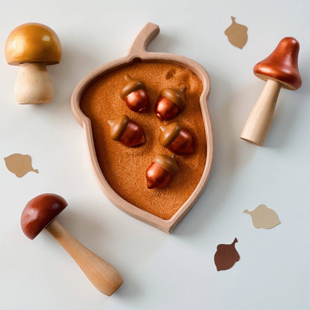 acorn shaped wooden Montessori sorting tray filled with painted wooden acorns and mushroom toys