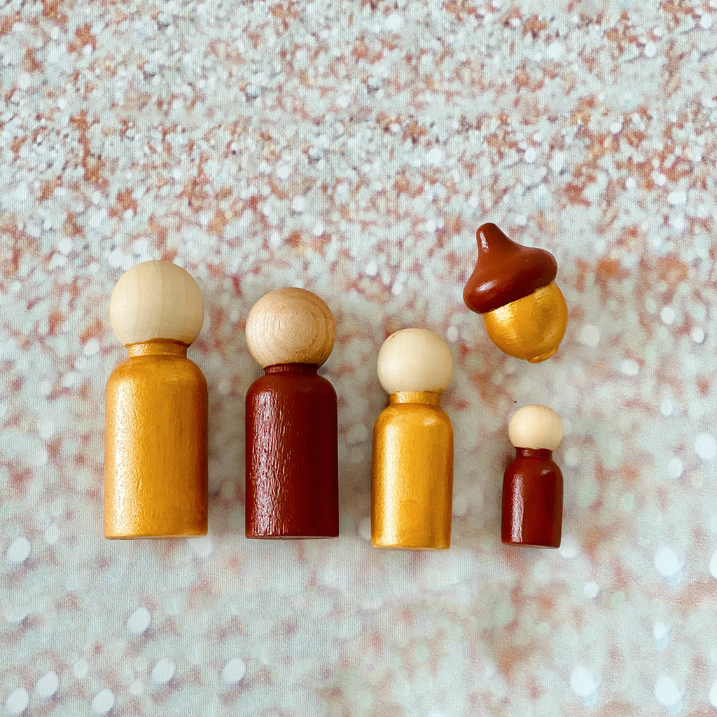 brown and gold wooden peg dolls