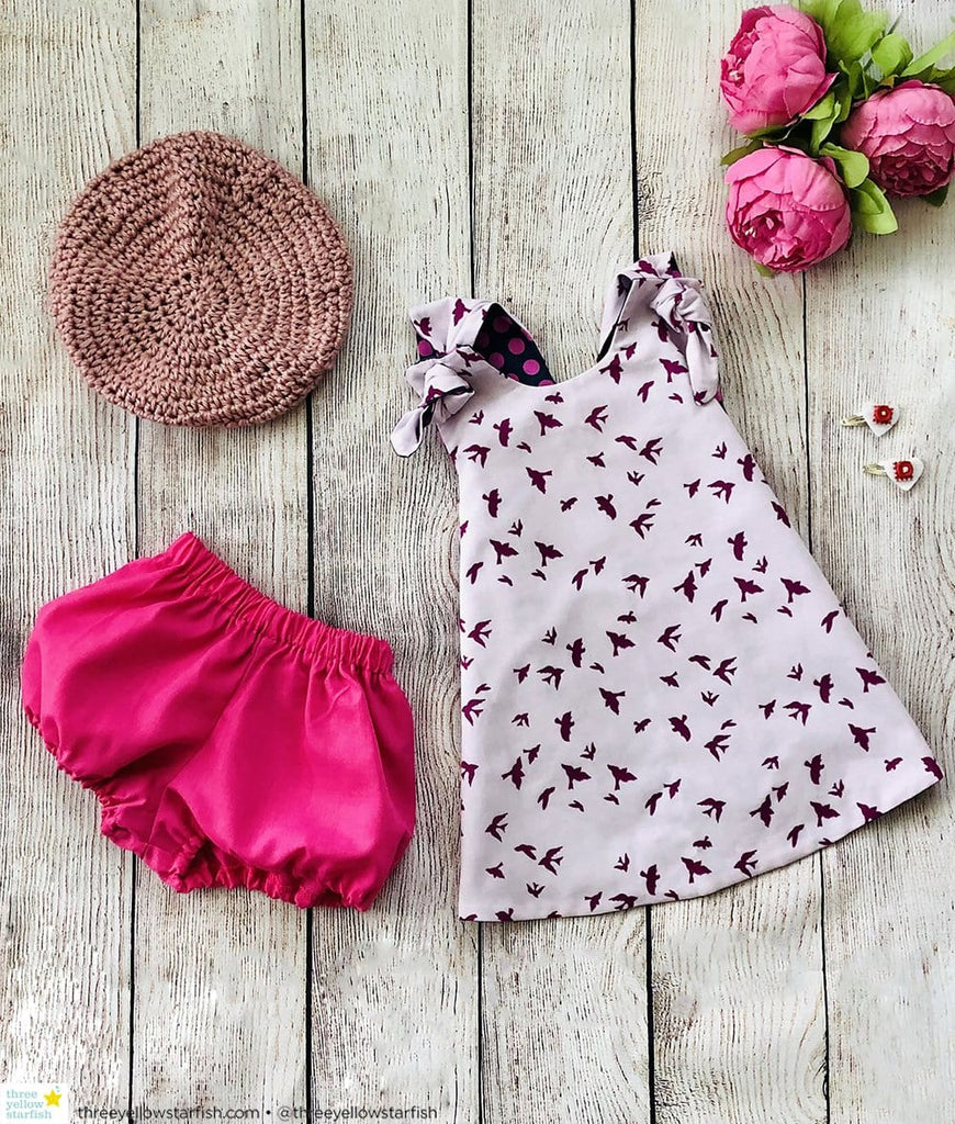 purple baby girl dress with matching toddler hat and baby girl bloomers