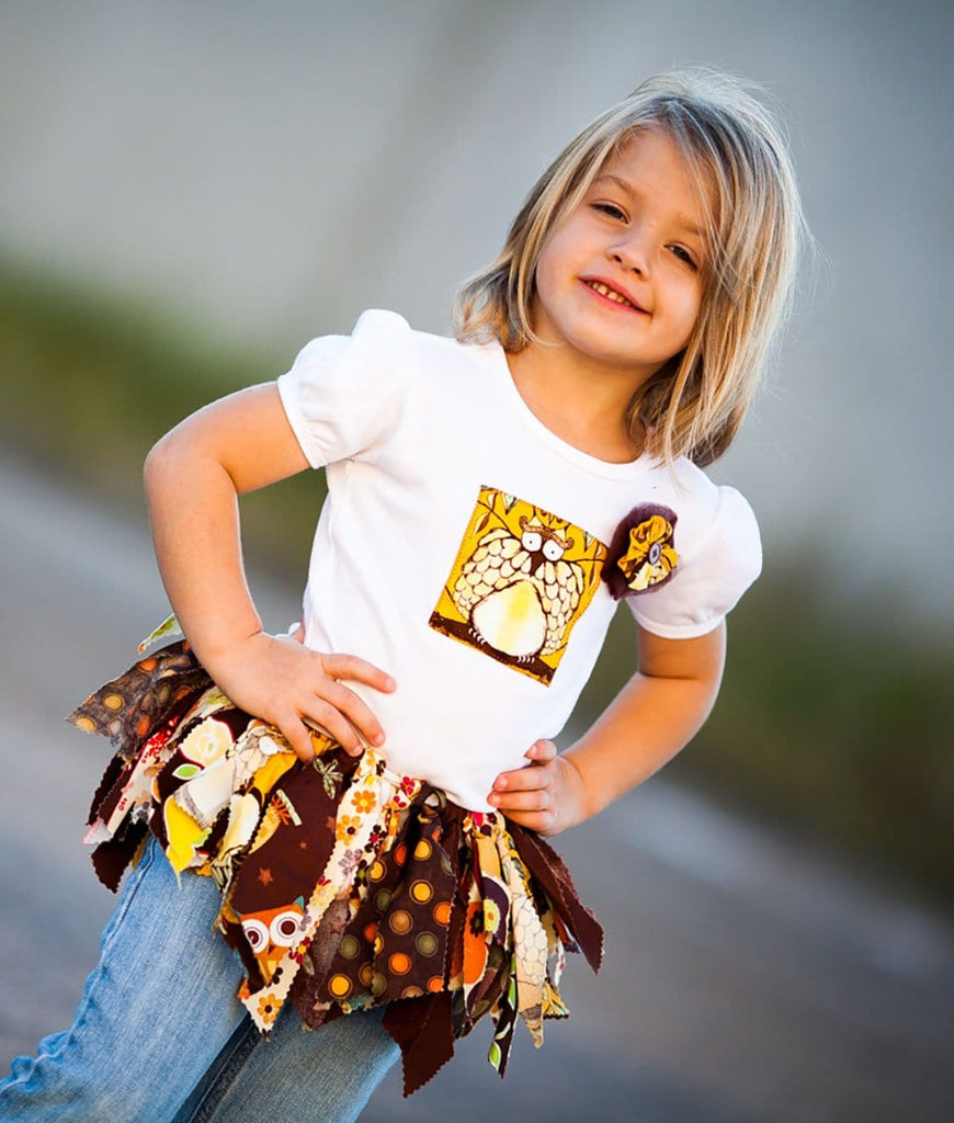 little girl wearing a brown and yellow tutu for baby and toddler